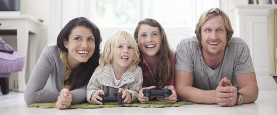 Family playing video game in living room